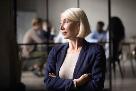 Thoughtful businesswoman standing looking through window