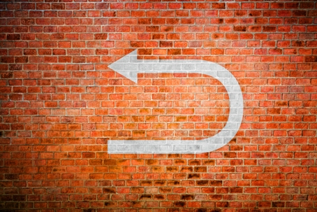 White Turnaround Sign On Vintage Brick