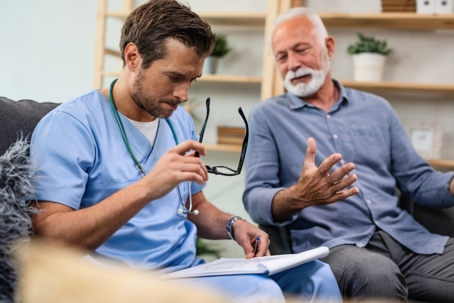 Doctor reviewing medical reports with senior patient