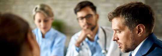 Physicians in a meeting with an attorney to discuss a Health Care Start-up.