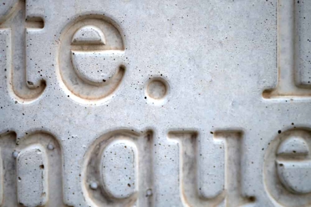 Close-up of words carved into stone.