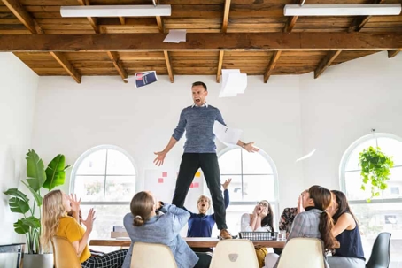 Angry businessman standing over the table in a meeting.