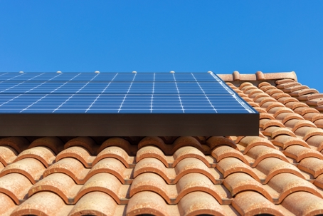 Roof with solar panels and blue sky