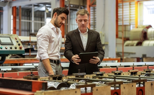 The owner of the factory holds the tablet