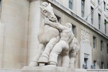 "Man Controlling Trade" statue depicting a man holding back a horse by the reins in front of the Federal Trade Commission Building.