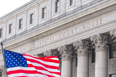 USA national flag waving in the wind in front of United States Court House in New York