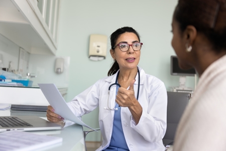 Friendly physician giving a consultation to her patient.