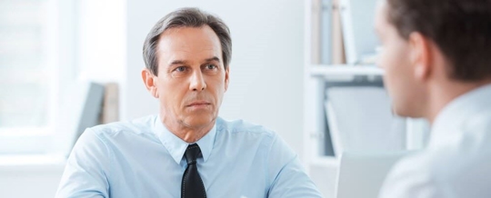 Two businessmen in a meeting discussing a bankrupt client