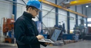 Job site manager looking at laptop