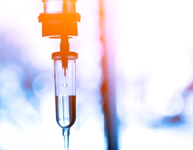 Saline iv bag intravenous drip hospital room,Medical Concept,treatment patient emergency and injection drug infusion care chemotherapy concept.blue light background hospital,Selective focus